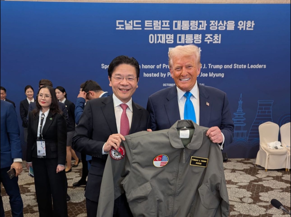 Singapore PM Lawrence Wong presents President Trump with a customised RSAF bomber jacket, symbolising Singapore-US defence ties. — Picture via Facebook/Lawrence Wong