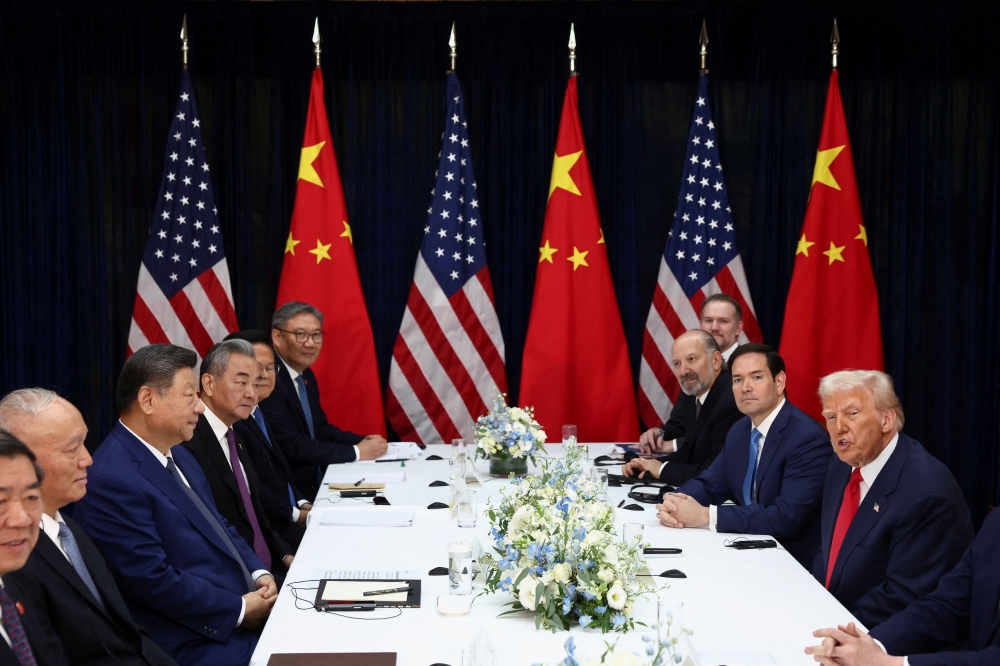 US President Donald Trump, accompanied by US Secretary of State Marco Rubio, and US Secretary of Commerce Howard Lutnick, attends a bilateral meeting with Chinese President Xi Jinping, accompanied by Chinese Foreign Minister Wang Yi, at Gimhae International Airport, on the sidelines of the Asia-Pacific Economic Cooperation (Apec) summit, in Busan, South Korea, October 30, 2025. — Reuters pic