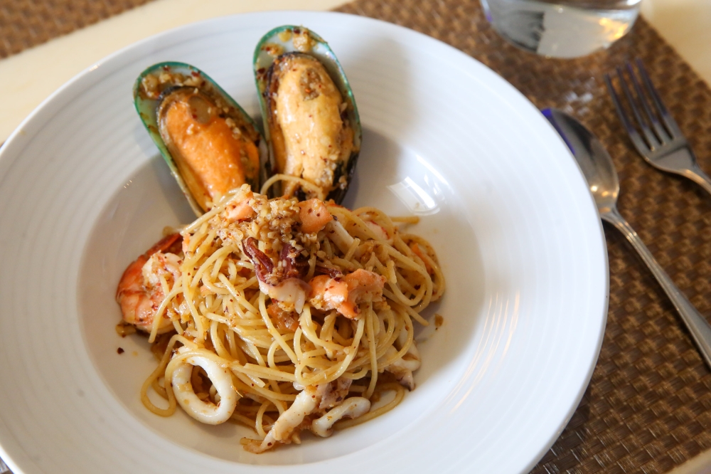 Spaghetti Aglio Olio is given more flavour with the use of finely diced garlic sautéed in oil, dried chilli flakes and fresh seafood. — Picture by Choo Choy May