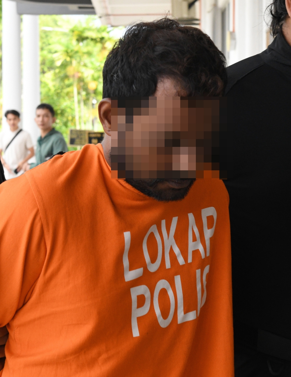 Earlier, the main suspect, along with two other men of the same nationality, including the main suspect’s brother, arrived at the court at 9am separately wearing police lockup attire. — Bernama pic 