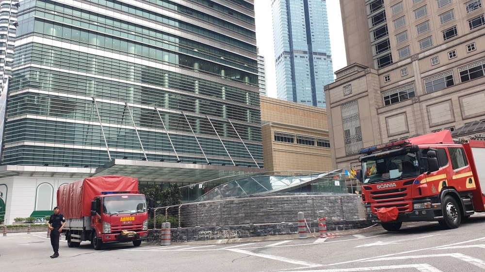 Fire and rescue units from three stations were deployed this morning to contain the fire at KLCC Tower 3. — Picture by Milad Hassandarvish