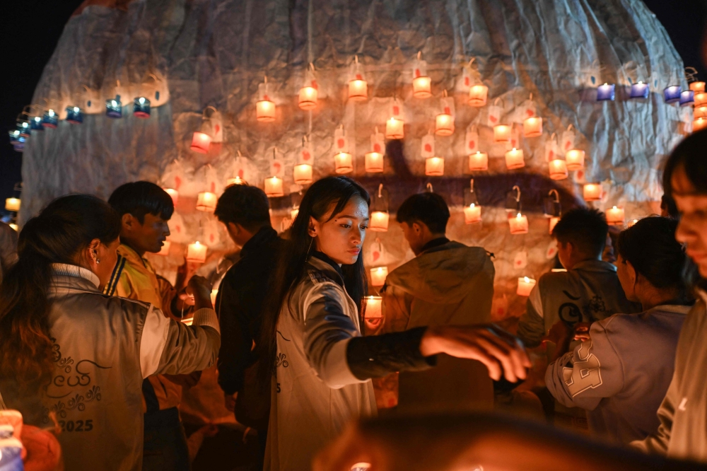 This picture taken on October 30, 2025 shows participants preparing candles as they set up a hot air balloon to be released loaded with fireworks during the Tazaungdaing Lighting Festival in Taunggyi in Myanmar's northeastern Shan State. — AFP pic