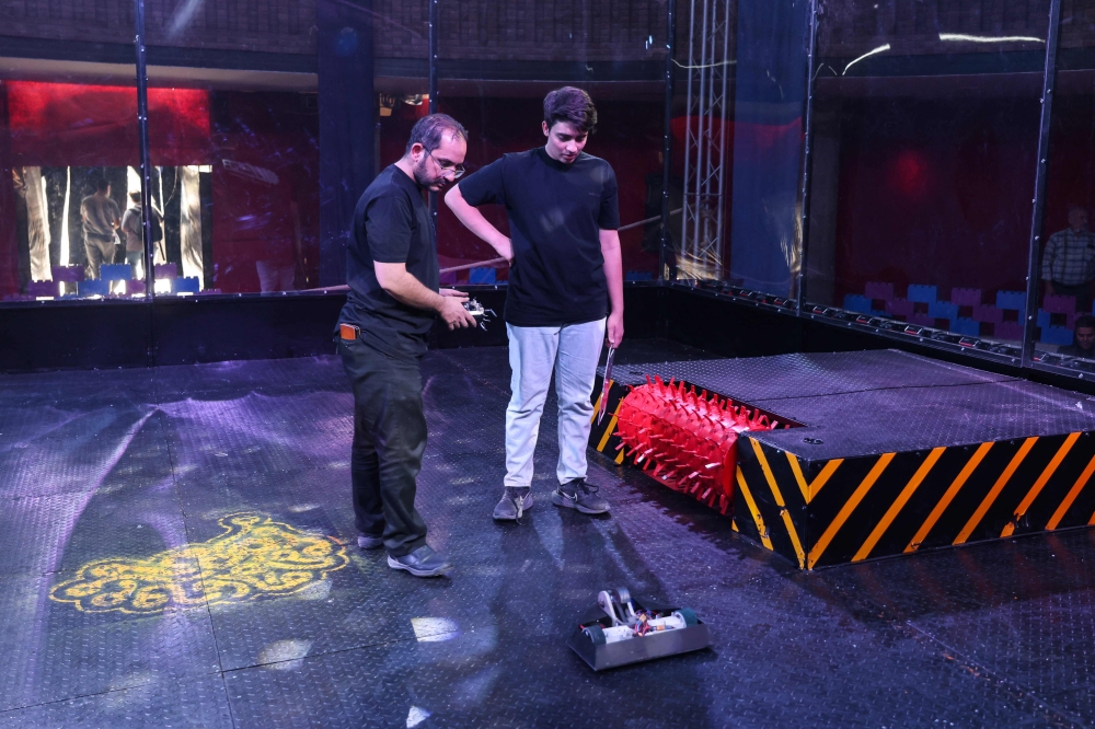 Engineering students prepare their robot for a battle event during the second edition of the International Technology Olympics held at Pardis Technology Park, on the eastern outskirts of Tehran on October 28, 2025. — AFP pic