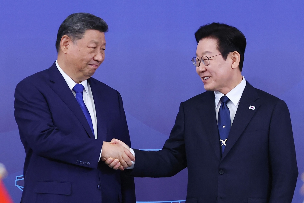South Korea's President Lee Jae Myung (right) and China's President Xi Jinping shake hands ahead of the South Korea-China summit held at the Gyeongju National Museum in Gyeongbuk Province on November 1, 2025. — Yonhap via AFP pic