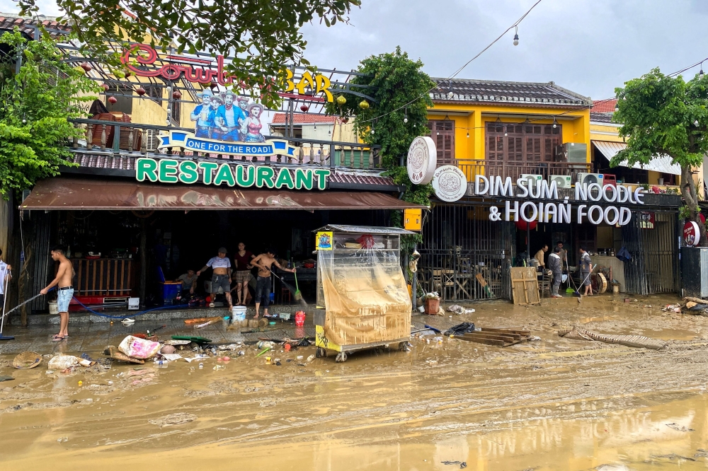 People clean a restaurant following floods in central Vietnam that have killed several people, in Hoi An, Vietnam  November 1, 2025. — Reuters pic