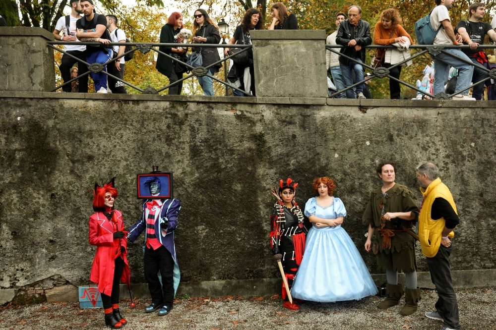 Cosplayers pose in elaborate costumes during the Lucca Comics & Games 2025 event, one of the Europe's largest pop culture conventions, as stars and creators of 'Stranger Things' series launch Season 5, in Lucca, Italy October 31, 2025. — Reuters pic