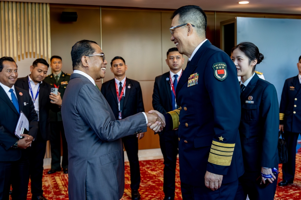 Datuk Seri Mohamed Khaled Nordin meets with Chinese Defence Minister Dong Jun during the Asean-China Defence Ministers Luncheon on the sidelines of ADMM at KLCC on October 31, 2025. — Picture by Firdaus Latif
