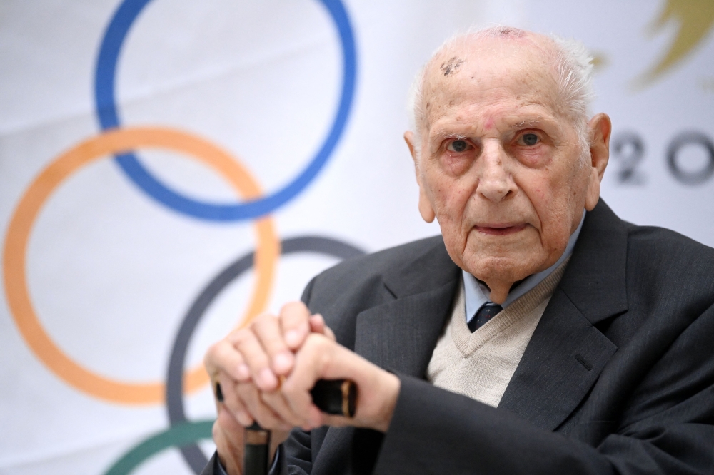 This file picture shows the late French cyclist, and Olympic champion in the team pursuit during the 1948 Summer Olympics in London, Charles Coste attending a ceremony to receive the Legion d'onneur at the headquarters of the Paris 2024 Organising Committee for the Olympic and Paralympic Games, in Saint-Denis, outside Paris, on April 13, 2022. — AFP pic