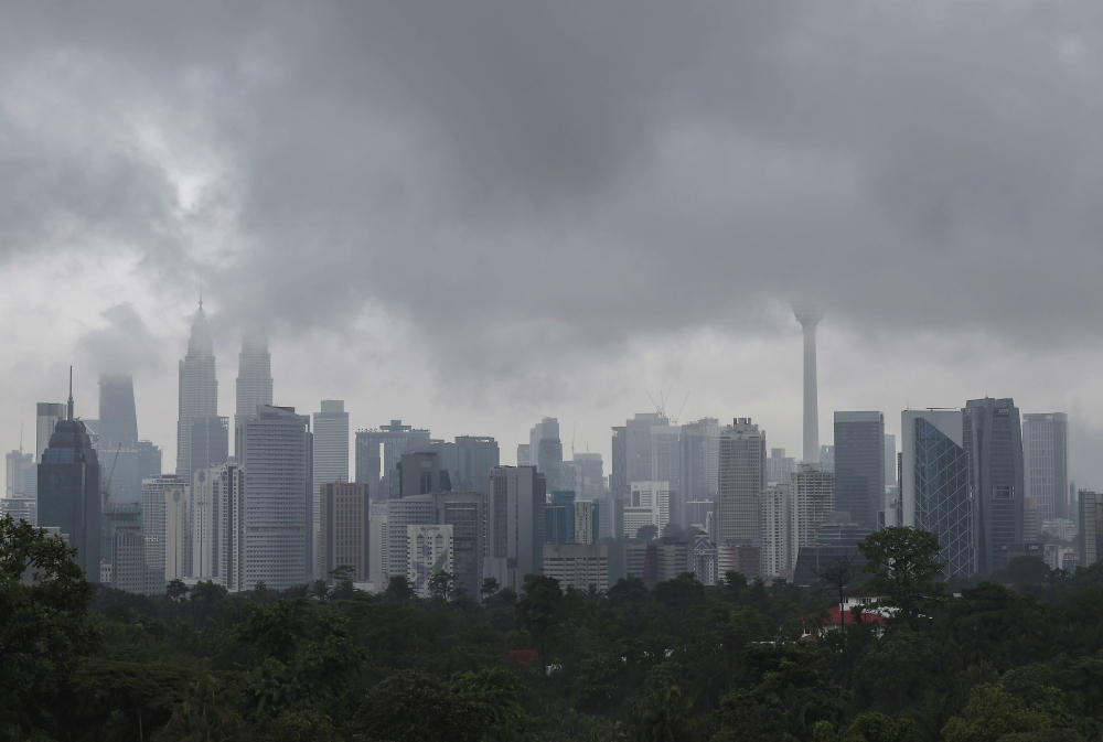 The Petronas Twin Towers and Kuala Lumpur Tower are shrouded in clouds on August 11, 2024. — Bernama pic
