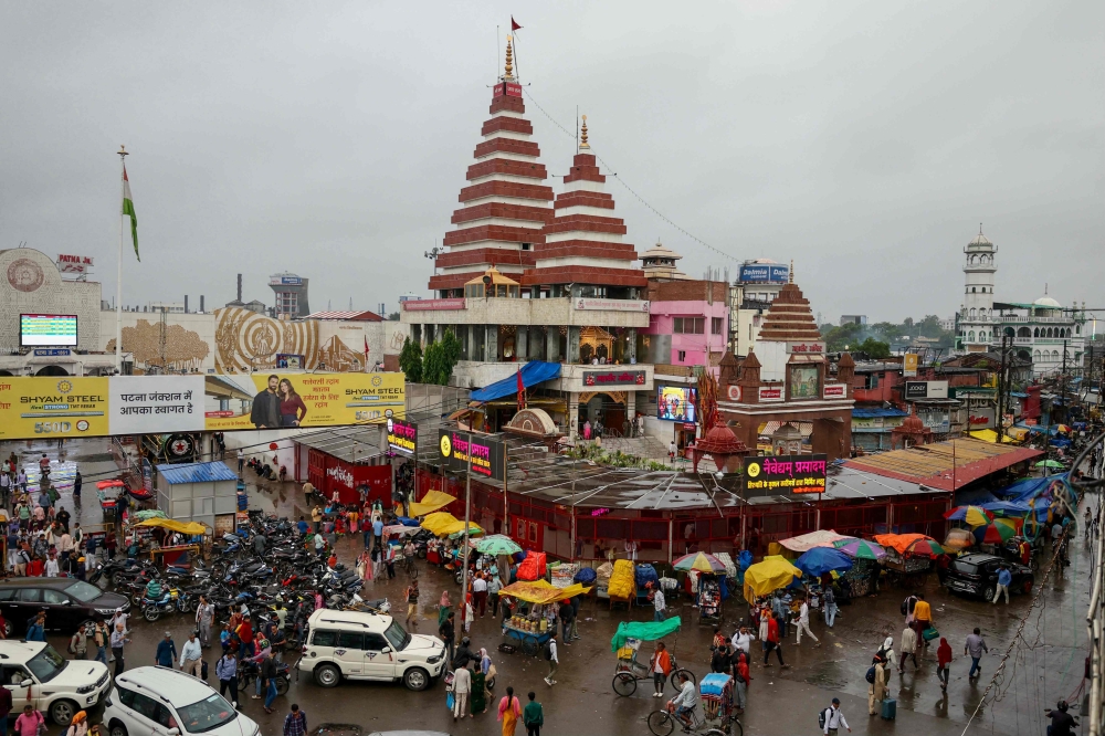 People gather next to the Hindu Mahavir Temple in Patna on November 1, 2025. — AFP pic