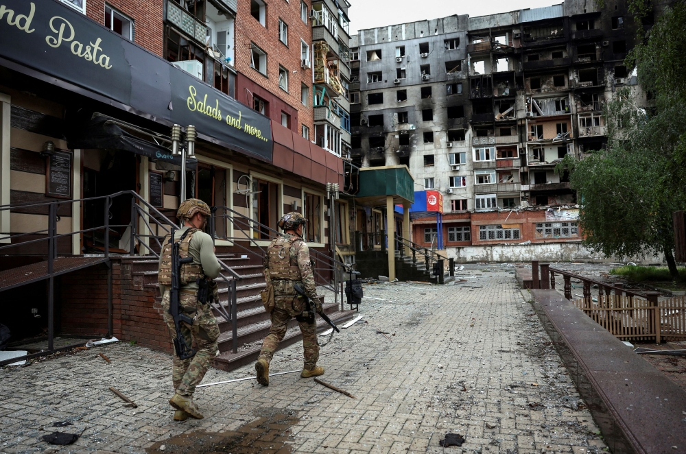 Members of the White Angel unit of Ukrainian police officers who evacuate people from the frontline towns and villages, check an area for residents, amid Russia's attack on Ukraine, in the frontline town of Pokrovsk in Donetsk region, Ukraine May 21, 2025. — Reuters pic