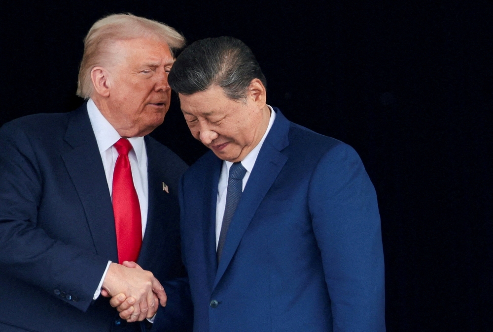 US President Donald Trump and Chinese President Xi Jinping talk as they leave after a bilateral meeting at Gimhae International Airport, on the sidelines of the Asia-Pacific Economic Cooperation (Apec) summit, in Busan, South Korea, October 30, 2025. — Reuters pic