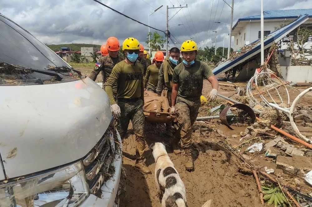 In this handout photo taken on November 5, 2025 and released by the Philippine Army’s Public Affairs Office (ARMY-PAO), army personnel from the 53rd Enginering Brigade carry the body of a missing person on a stretcher in the aftermath of Typhoon Kalmaegi during a retrieval operation in Liloan town, Cebu province, central Philippines. — Philippine Army handout pic via AFP