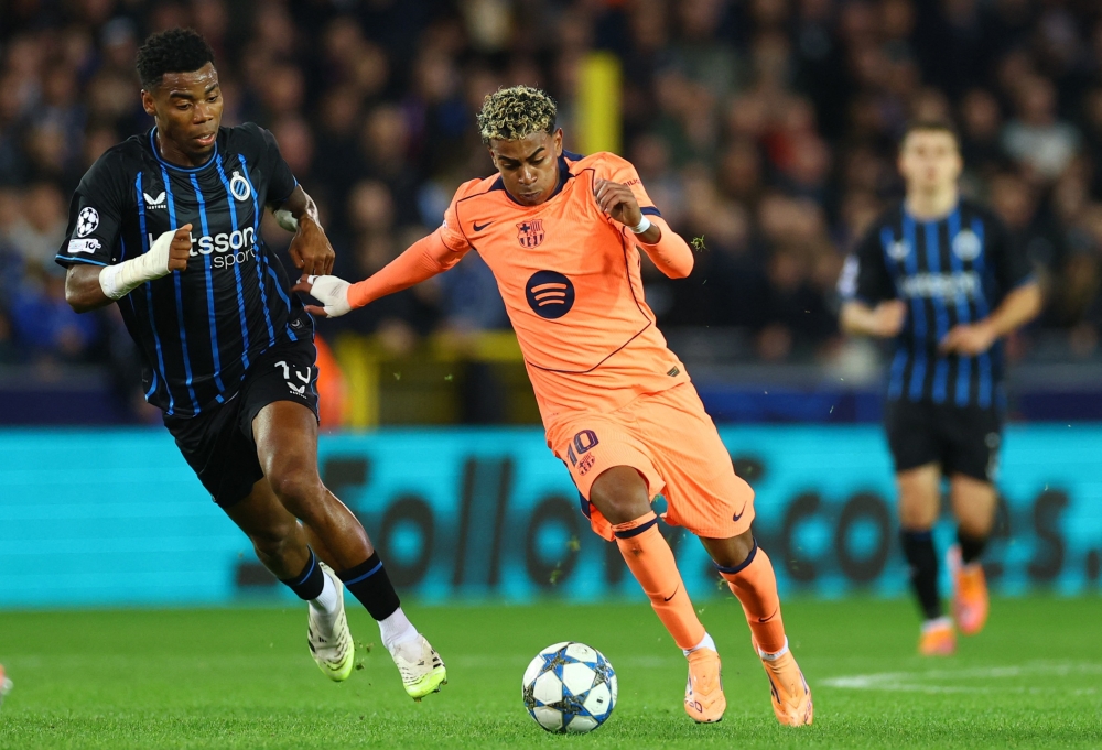 FC Barcelona’s Lamine Yamal in action with Club Brugge’s Raphael Onyedika at Jan Breydel Stadium, Bruges, November 5, 2025. — Reuters pic 
