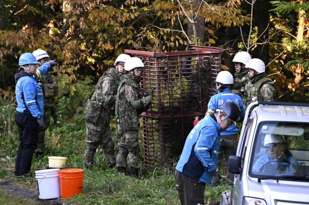 Members of Japan Self-Defense Forces (JSDF) set up a bear trap in Kazuno, Akita Prefecture, Japan, in this photo taken by Kyodo November 5, 2025. — Kyodo handout pic via Reuters 