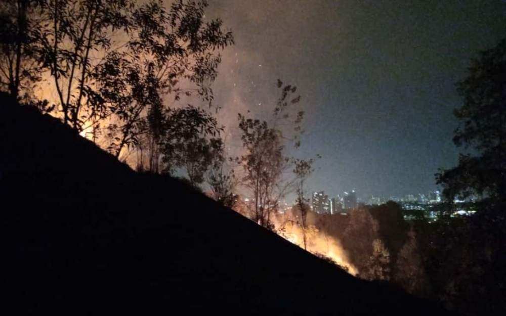 Firefighters extinguished a 2.4-hectare forest fire in the hilly area of Taman Seri Timah, Balakong, after more than five hours of operations overnight. — Picture courtesy of Selangor Fire and Rescue Department