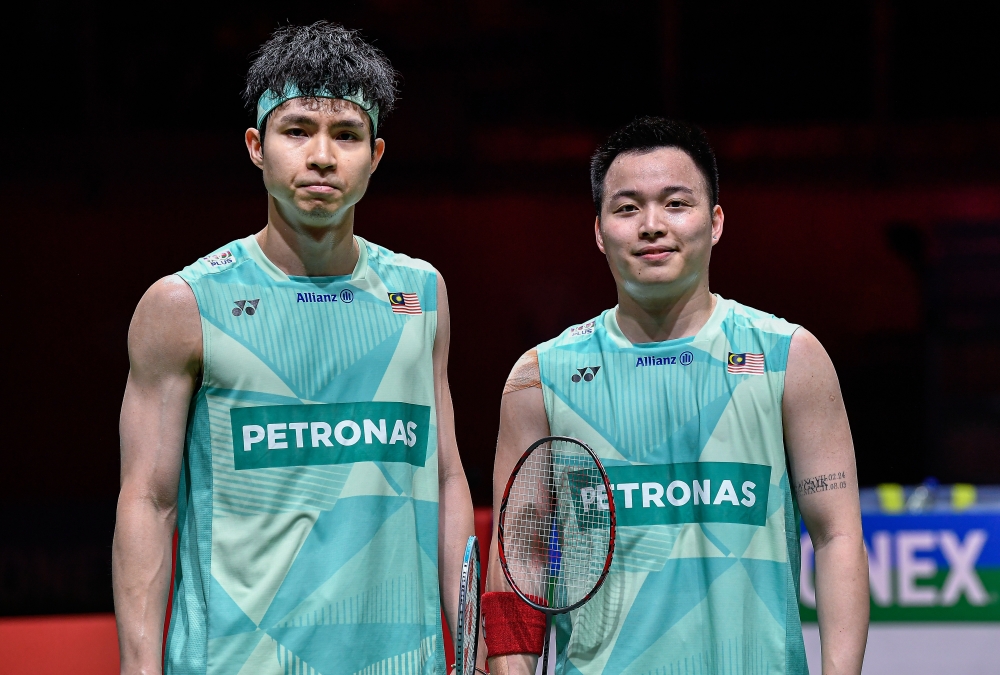 Aaron Chia (right) said he is open to switching partners at the 2025 SEA Games — a strategic move he believes could give Malaysia an edge in the hunt for badminton gold. He is pictured with with his regular men’s doubles partner, Soh Wooi Yik (left). — Bernama pic