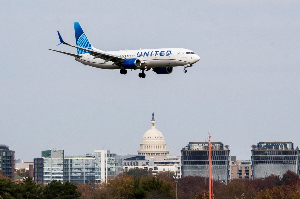 A United Airlines flight lands in front of the U.S. Capitol at Ronald Reagan Washington National Airport as the Trump administration warns of impending cuts to commercial airline operations more than a month into the continuing US government shutdown in Arlington, Virginia November 7, 2025. — Reuters pic