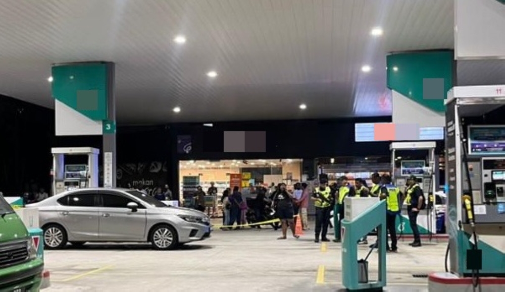 Police officers inspect the scene where a 31-year-old man was shot at a petrol station in Bukit Tinggi, Klang, November 7, 2025. — Picture via Facebook