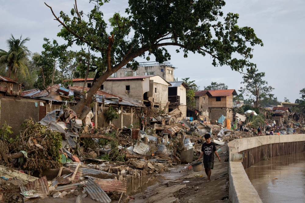 A boy walks along the remains of a community where houses were swept in the floods brought on by Typhoon Kalmaegi in Talisay, Cebu, Philippines November 6, 2025. — Reuters pic  