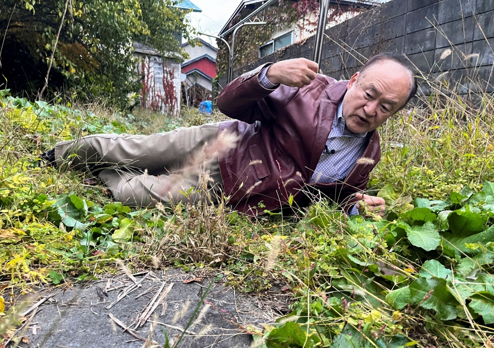 Keiji Minatoya, 68, a confectionery shop owner who was attacked by a black bear in front of the garage in his backyard on October 19, 2023, explains the situation at the time, in Kitaakita, Akita Prefecture, Japan November 6, 2025. — Reuters pic 