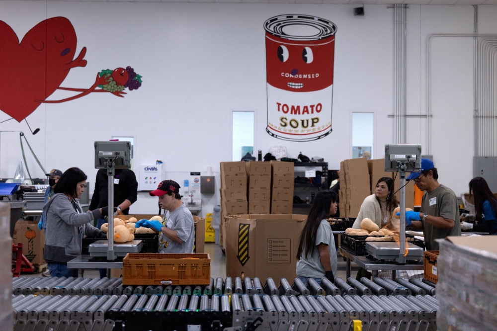 Volunteers weigh squash and potatoes to add to produce bags for mobile party distribution sites at the Central Texas Food Bank warehouse kitchen, as nearly 42 million Americans face a potential lapse in Supplemental Nutrition Assistance Programme (SNAP) benefits, known as food stamps, due to the second-longest US government shutdown, in Austin, Texas October 30, 2025. — Reuters pic  