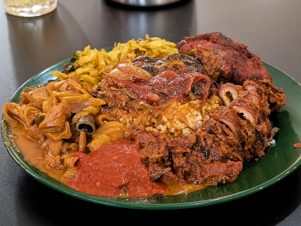 A fully loaded plate of ‘nasi kandar’ is always a sight that’s enough to make anyone weep tears of joy. — Picture by Ethan Lau