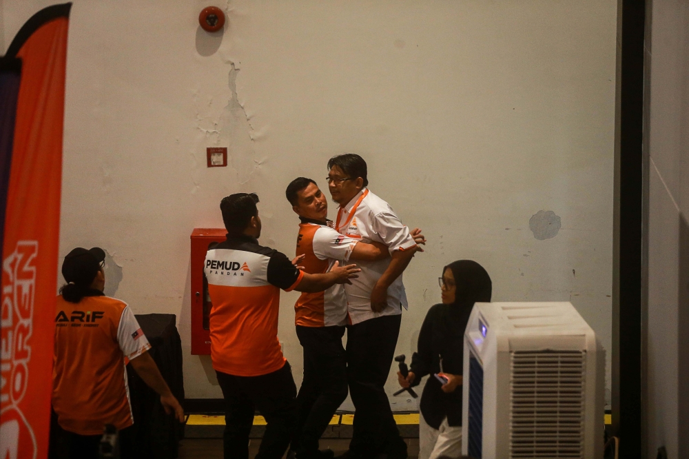 A delegate is escorted out of the hall after provoking one of the debaters during the 2025 Amanah National Convention in Shah Alam November 10, 2025. — Picture by Sayuti Zainudin