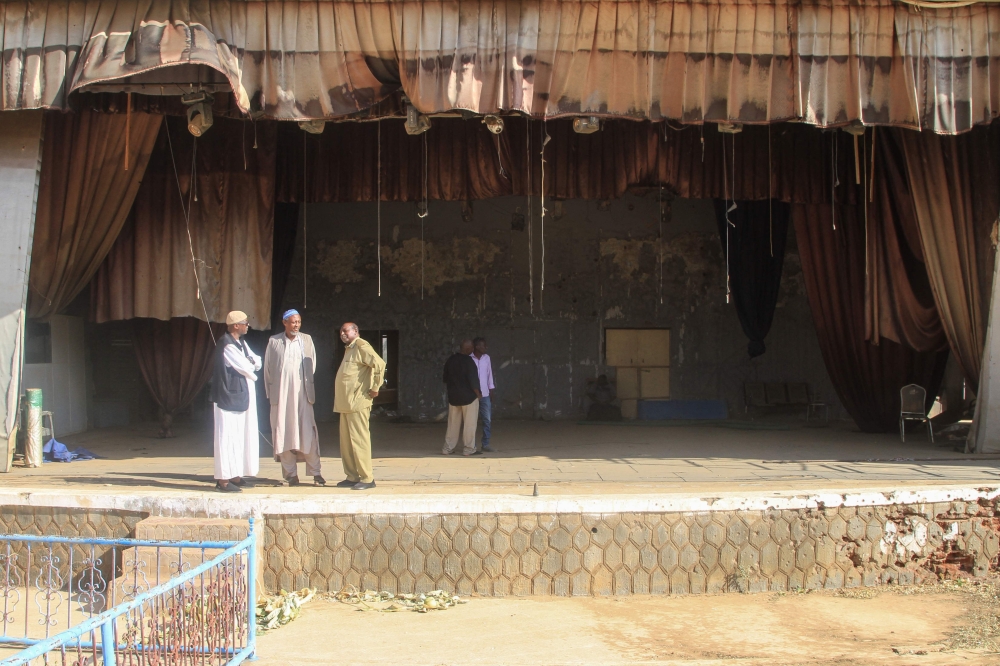 Men stand on the stage of the war-damaged National Theater of Omdurman, the twin-city of Sudan’s capital, as Sudanese dramatists and local authorities launch an initiative to restore it on November 7, 2025. — AFP pic