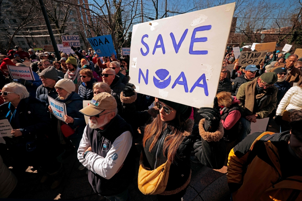 Demonstrators gather to protest against the Department of Government Efficiency (DOGE) cuts outside the headquarters of the National Oceanic and Atmospheric Administration in Silver Spring, Maryland, on March 3, 2025. — AFP pic