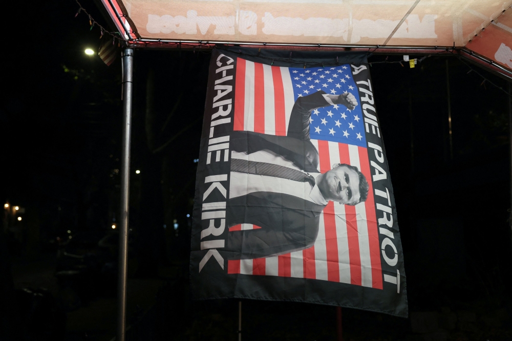 A flag featuring a picture of slain conservative commentator Charlie Kirk hangs outside a store in the Queens borough of New York City, U.S., on November 3, 2025. — Reuters pic