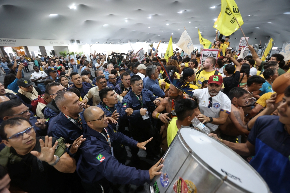 Demonstrators, including Indigenous people, take part in a protest as they force their way into the venue hosting the UN Climate Change Conference (COP30), in Belem, Brazil, November 11, 2025. — Reuters pic