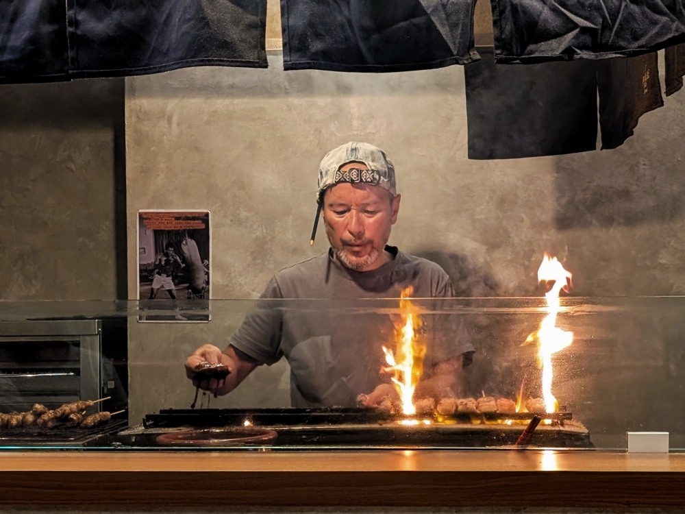 Chef Daiji Murasaki working the grill at his restaurant, Yakitori Lab Murasaki, in Solaris Mont Kiara. — Picture by Ethan Lau