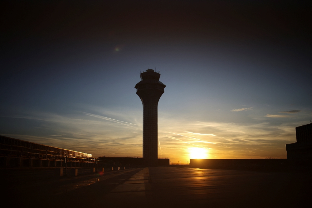 The sun sets over an air traffic control tower at O'Hare International Airport in Illinois, Chicago November 12, 2025. — Reuters pic