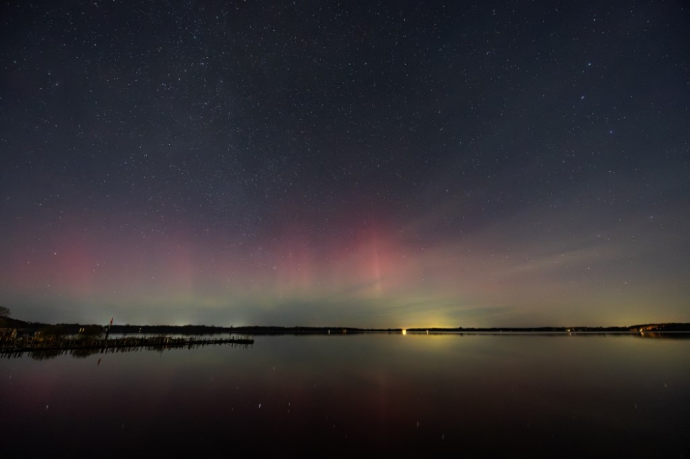 A powerful solar storm creates auroras over the Zwischenahner Meer in Lower Saxony November 13, 2025. — Markus Hibbeler/dpa/dpa Picture-Alliance pic via AFP
