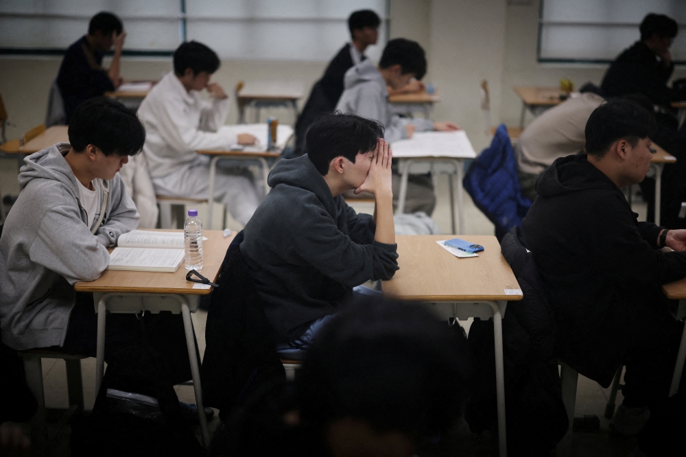 Students wait for the start of the annual college entrance examinations at an exam hall in Seoul November 13, 2025. — Kim Hong-Ji/Pool/Reuters pic