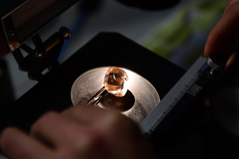 In this file photo taken on November 15, 2016 a diamond expert studies a diamond under an electronic microscope in Antwerp. — AFP pic
