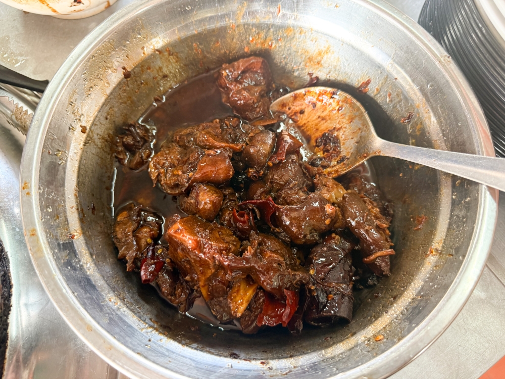 The ‘wantan mee’ stall offers a daily rotating menu of specials like this braised pork leg with your egg noodles. — Picture by Lee Khang Yi