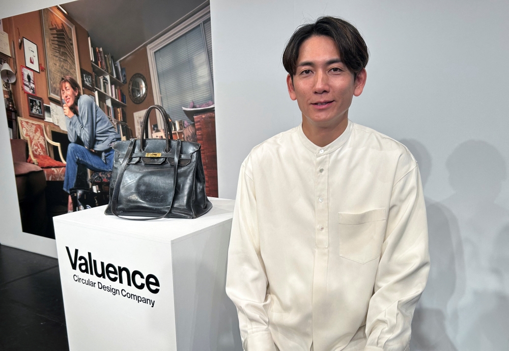 Valuence Japan CEO Shinsuke Sakimoto poses for a photograph next to the Original Birkin, the original bag custom-made for late actress Jane Birkin, which the Japanese company purchased for a record €8.6 million (RM41 million) at a Sotheby's auction in Paris earlier this year, during an unveiling event in Tokyo November 12, 2025. — Reuters pic 