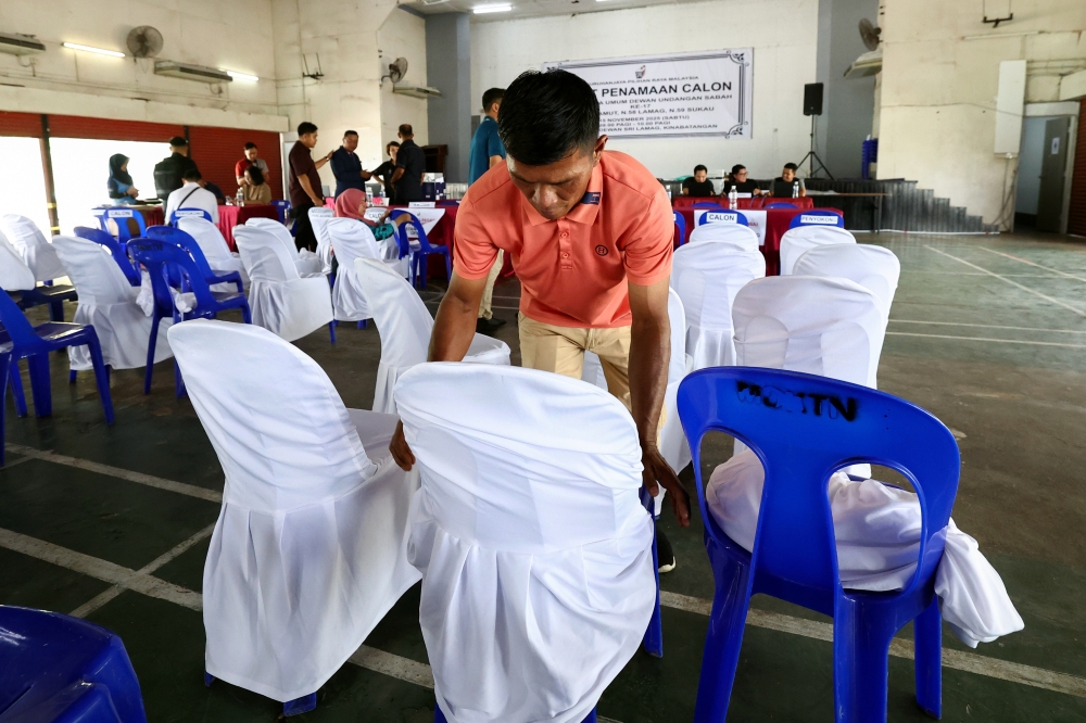 Election Commission personnel make final preparations for the Kuamut, Lamag and Sukau nominations at Dewan Sri Lamag, Kinabatangan yesterday. — Bernama pic