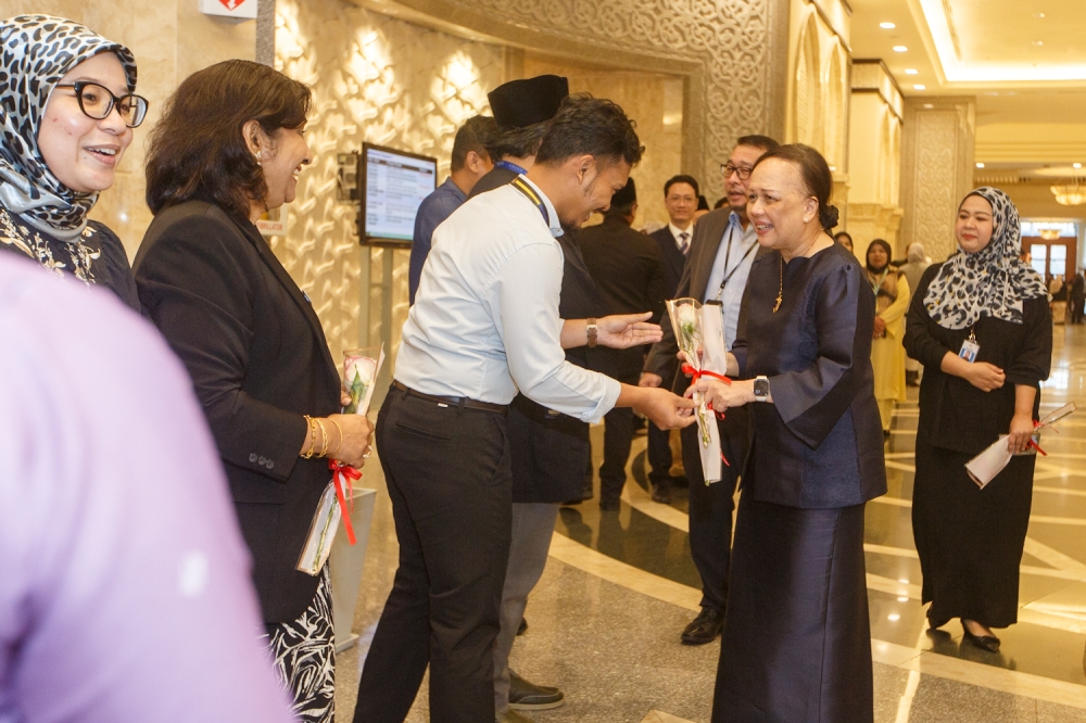Court personnel greet Tan Sri Hasnah Mohammed Hashim as the Chief Judge of Malaya for the last time, with some greeting or even giving her a farewell hug. — Picture by Raymond Manuel