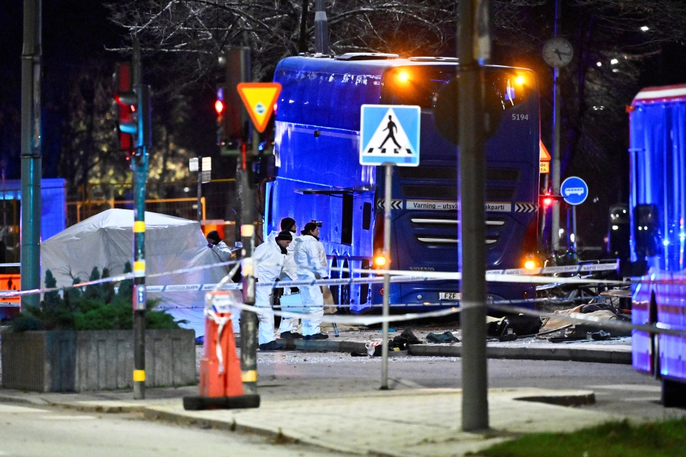 Police technicians work on the site where a bus hit into a bus shelter in Ostermalm in Stockholm, Sweden, November 14, 2025. — TT News Agency/Claudio Bresciani pic via Reuters 