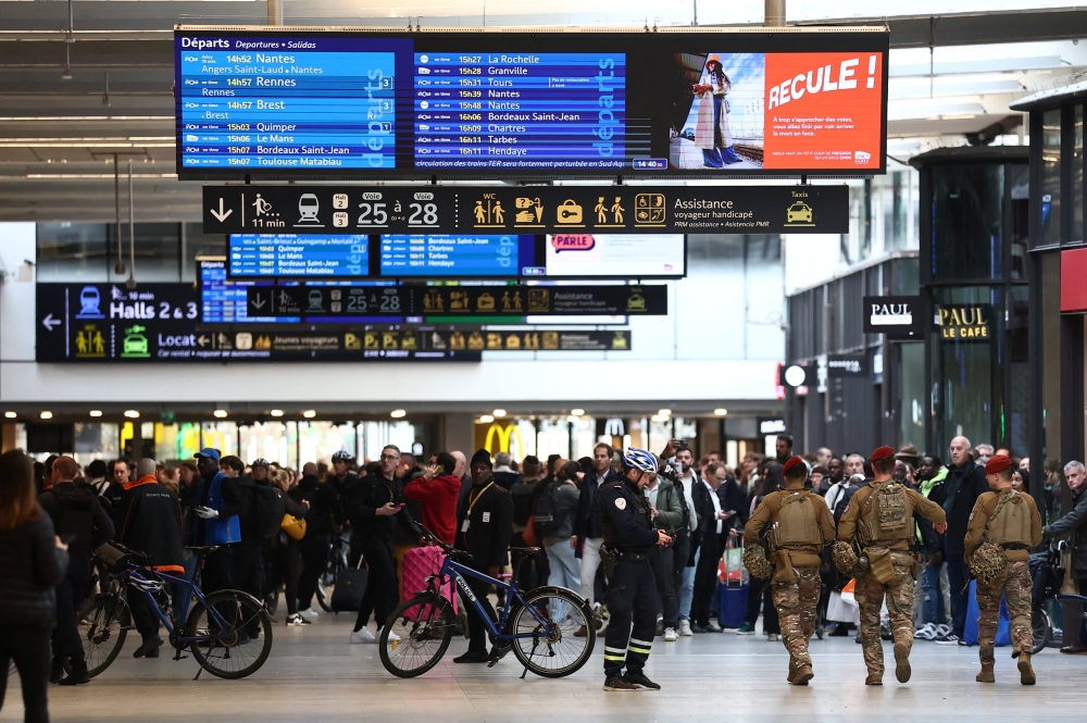 French police and soldiers secure the area at the Gare Montparnasse train station during its evacuation in Paris November 14, 2025. — Reuters pic  
