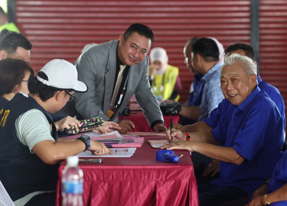 Barisan Nasional candidate for the Lamag state seat (N.58), Datuk Seri Moktar Radin, signs his nomination form at the Nomination Centre for the 17th Sabah state election at Dewan Sri Lamag in Kinabatangan November 15, 2025. — Bernama pic
