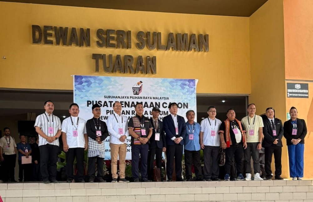 The 13 candidates who will contest for the Tamparuli seat. — The Borneo Post pic