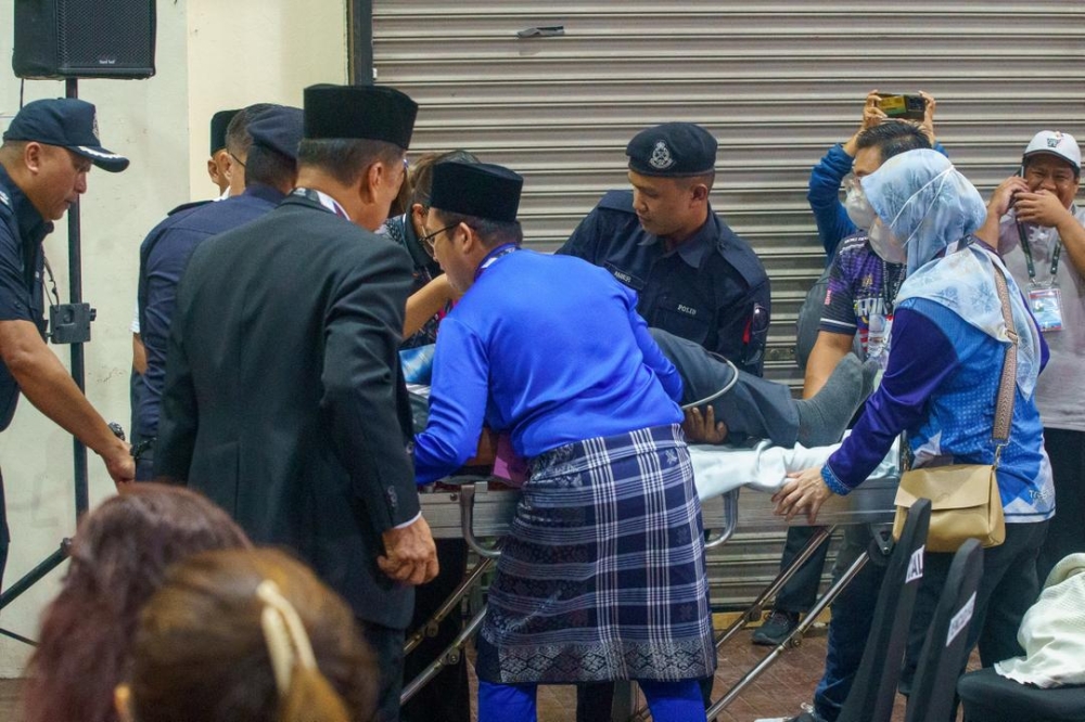 Dusi is placed on a stretcher. — The Borneo Post pic