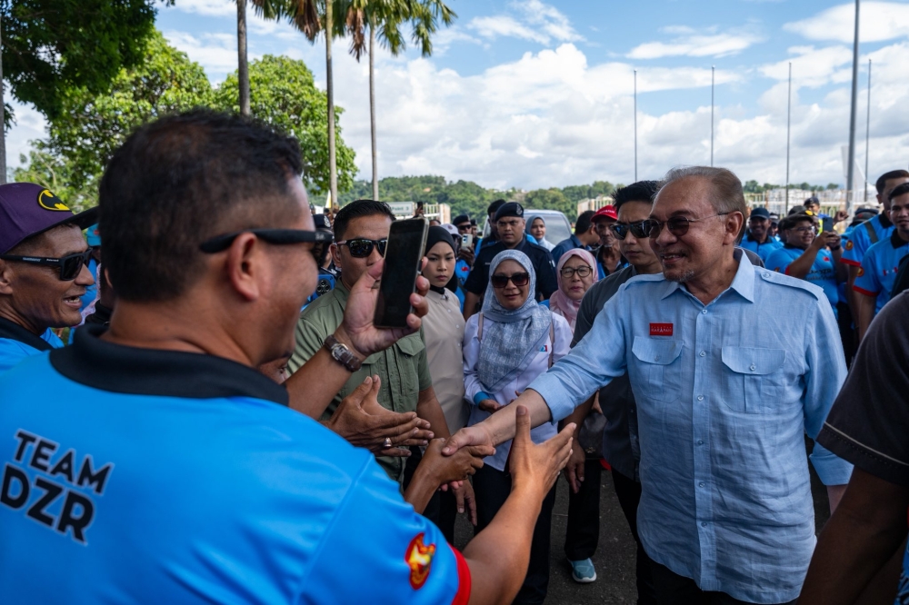 Datuk Seri Anwar Ibrahim interacts with members of the public upon landing at Kota Kinabalu International Airport (KKIA) in Tanjung Aru November 15, 2025. — Picture via Facebook/Anwar Ibrahim