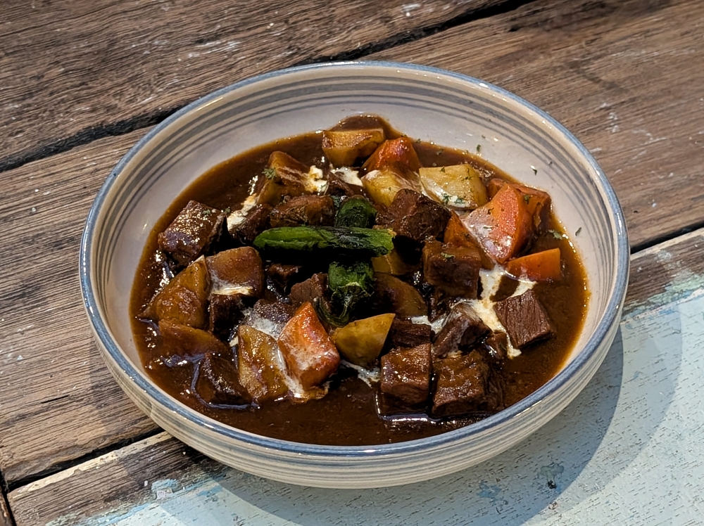 Warm and comforting, the ‘estofado de carne con vino tinto’ comes topped with a single grilled ‘padrón’ pepper for a bit of kick. — Picture by Ethan Lau