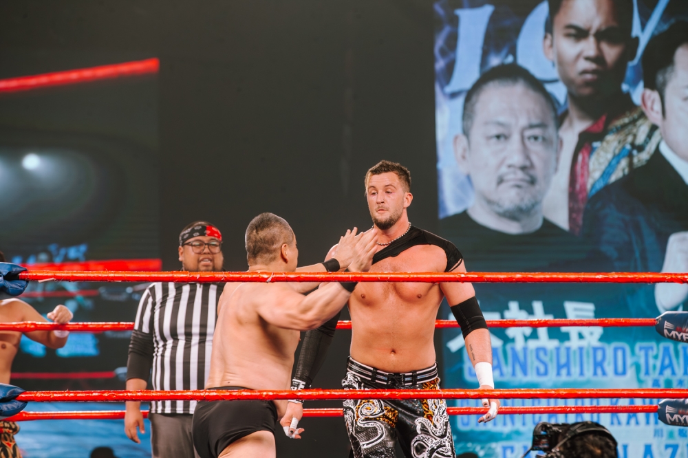Pro wrestler and one of the founders of DDT wrestling, Sanshiro Takagi facing Chris Brookes in the ring. — Picture by Raymond Manuel