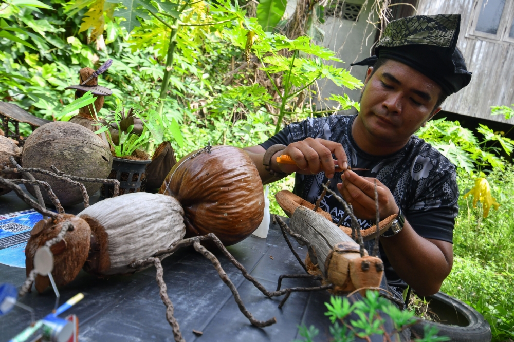 Kelantan homestay worker turns coconut waste into crafts sought by foreign tourists